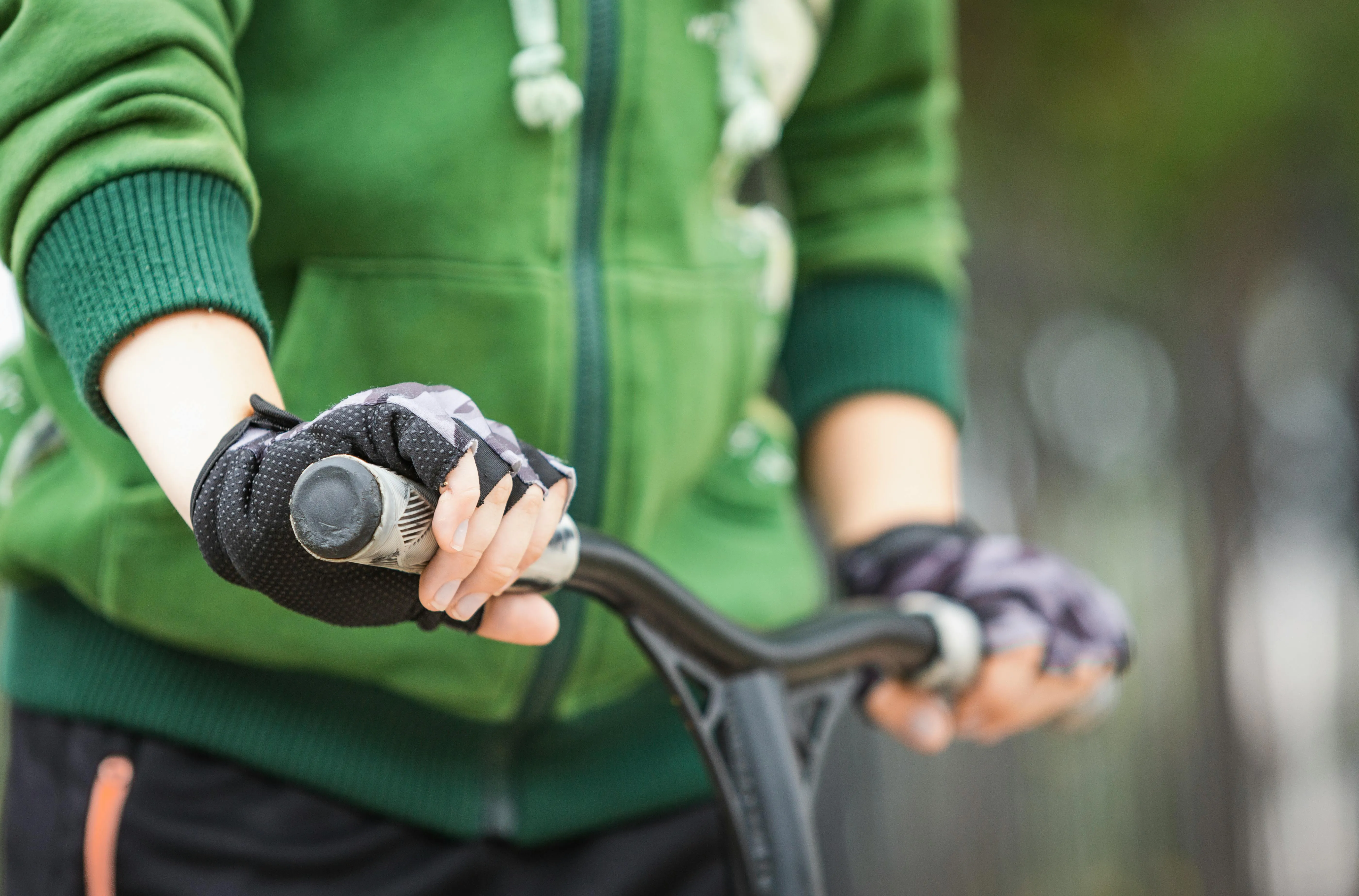 Hand gripping a bicycle handlebar